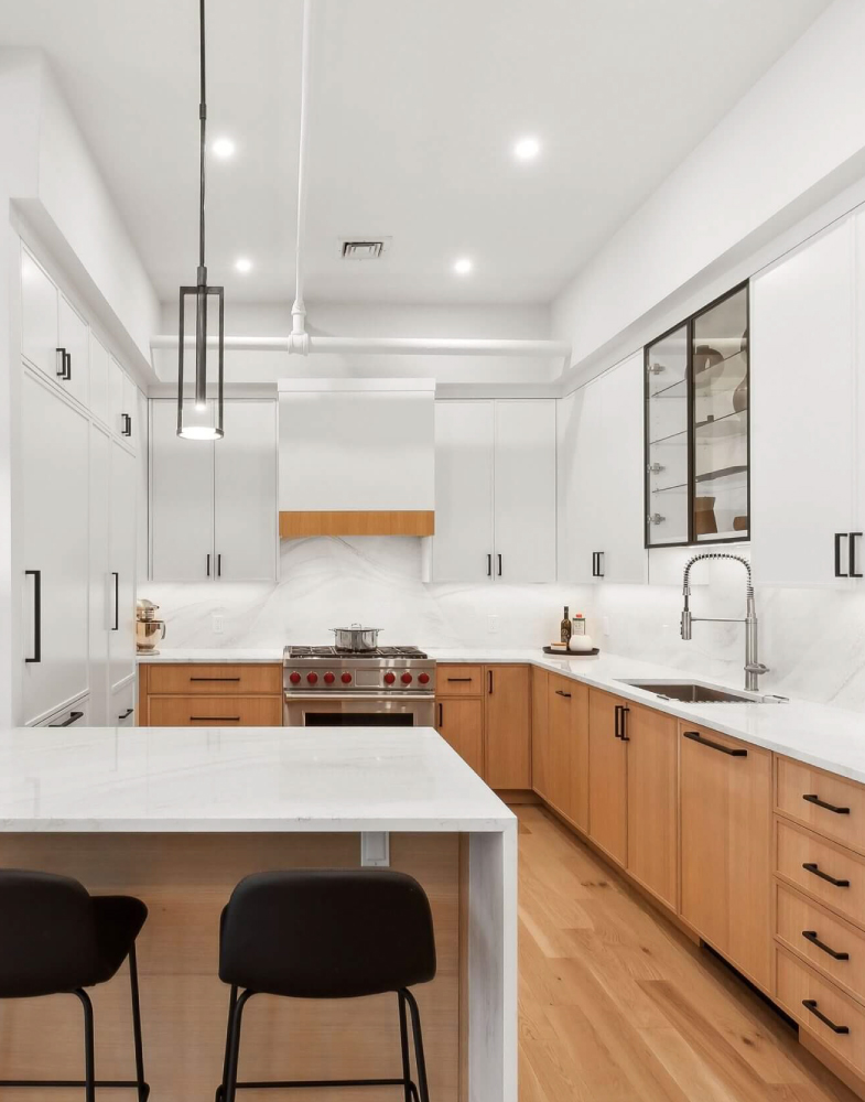 Modern kitchen design featuring custom cabinetry and high end appliances