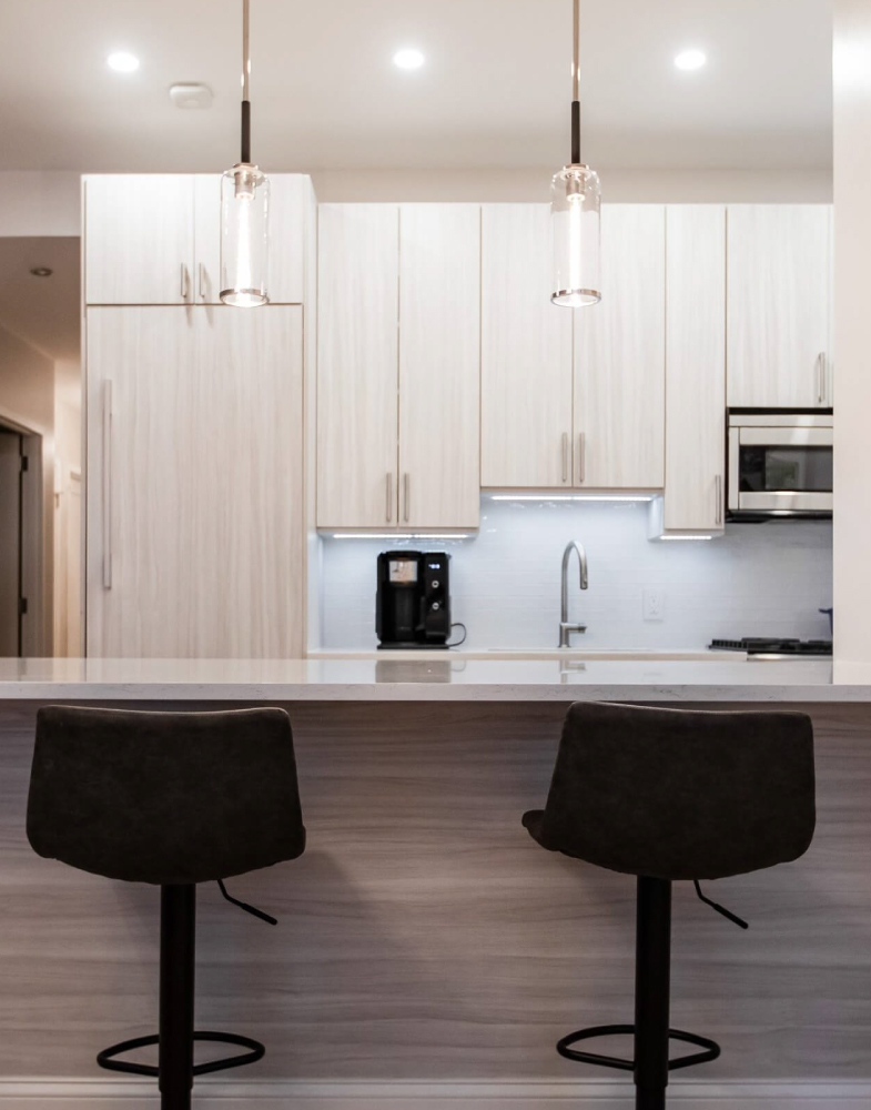Modern kitchen design with custom cabinetry and stylish bar stools